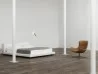 The Oolong armchair by Living Divani in a bedroom