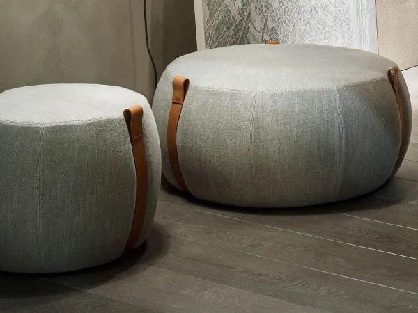 Notch pouf by Lema in fabric with leather straps
